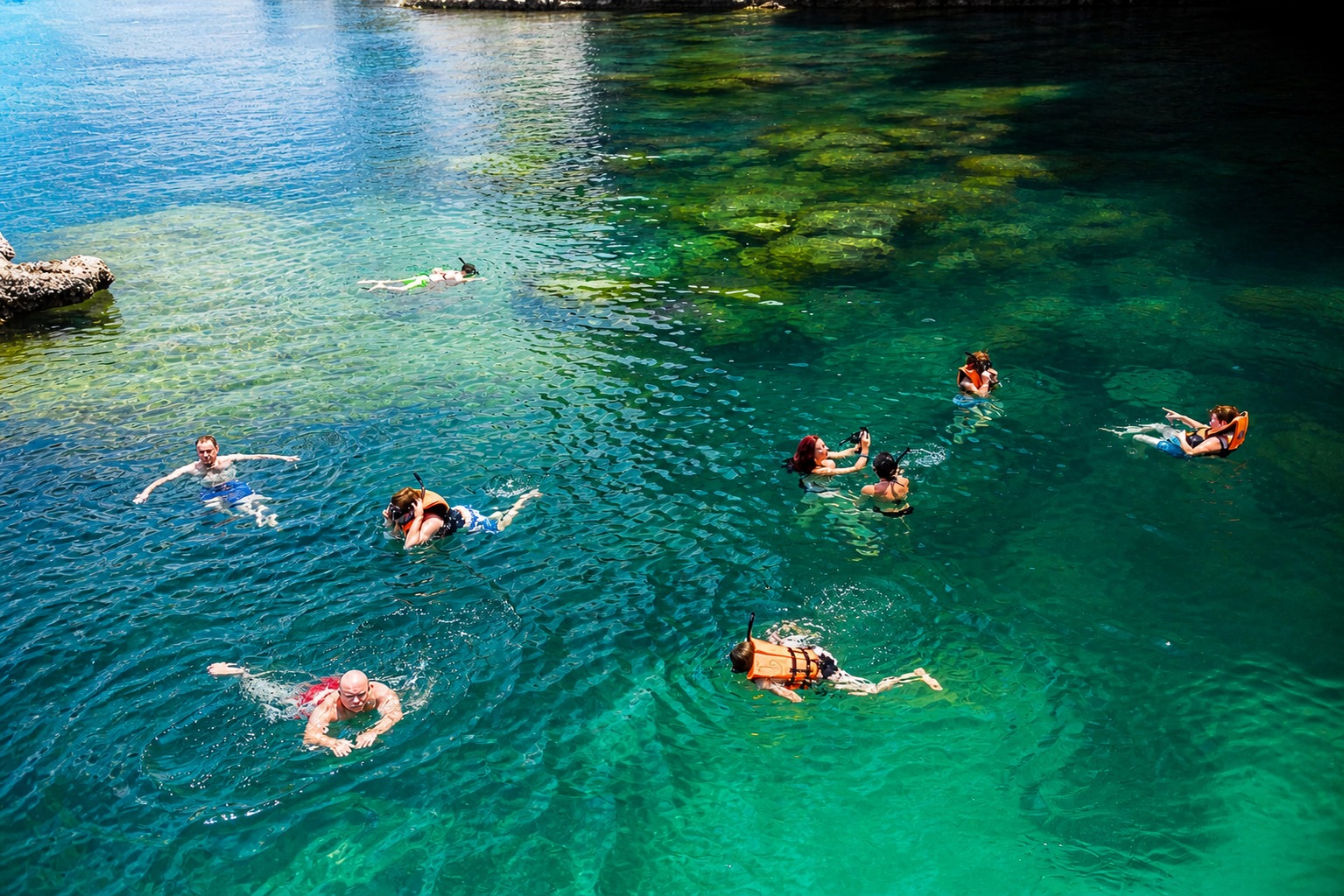Snorkellers swimming in a sheltered bay, Ang Thong Marine Park