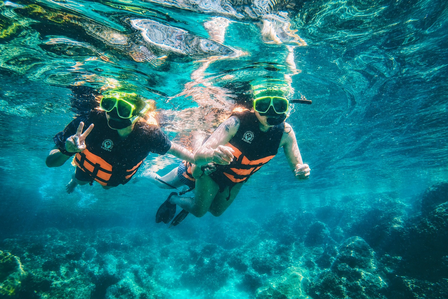 Underwater view of two guests snorkelling above the reef, Ang Thong Marine Park