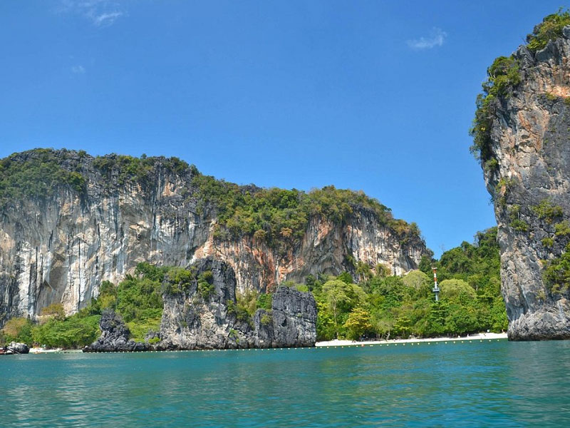 The dramatic limestone cliffs of Koh Hong rising straight out of the Andaman Sea